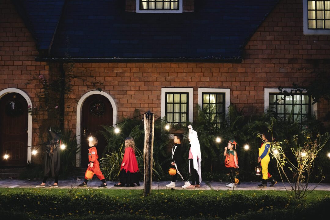 Group of kids with Halloween costumes walking to trick or treating Group of kids with Halloween costumes walking to trick or treating